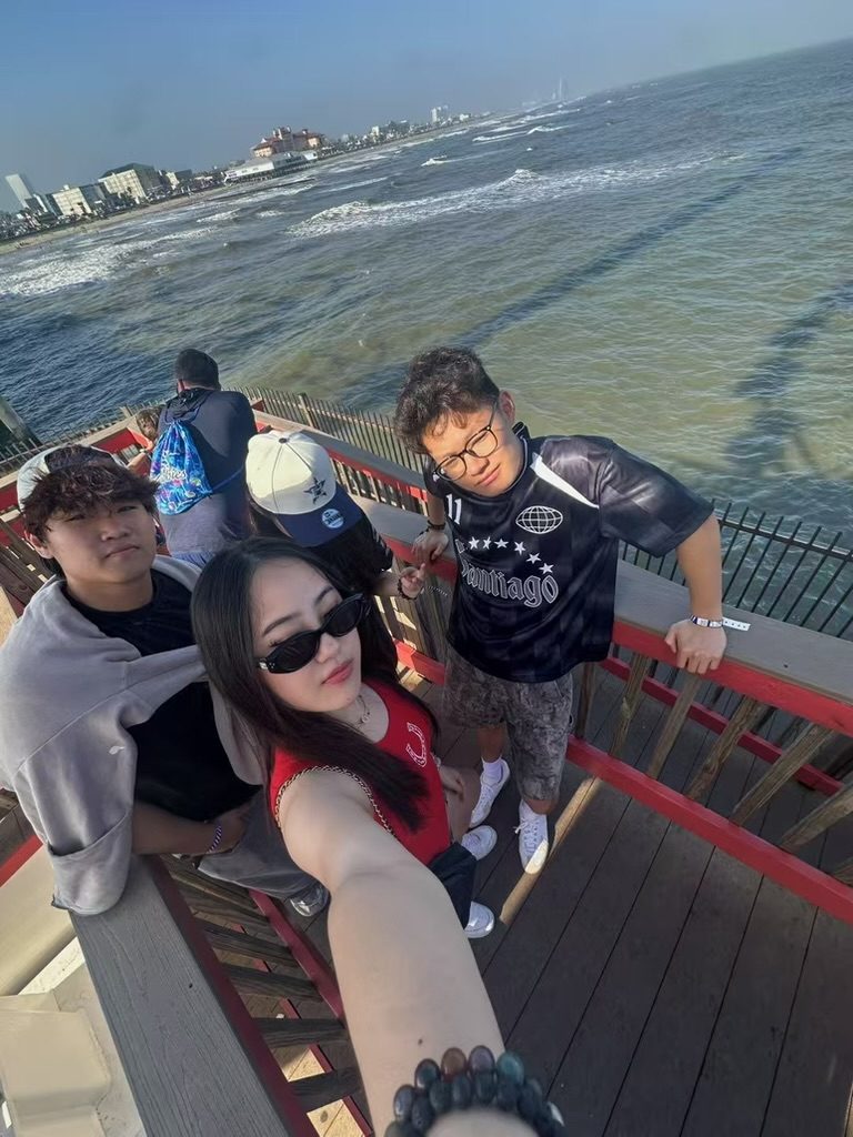 A group selfie on a seaside pier